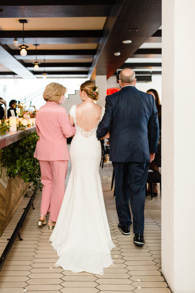 bride walking down aisle with mother and father at Hotel Figueroa