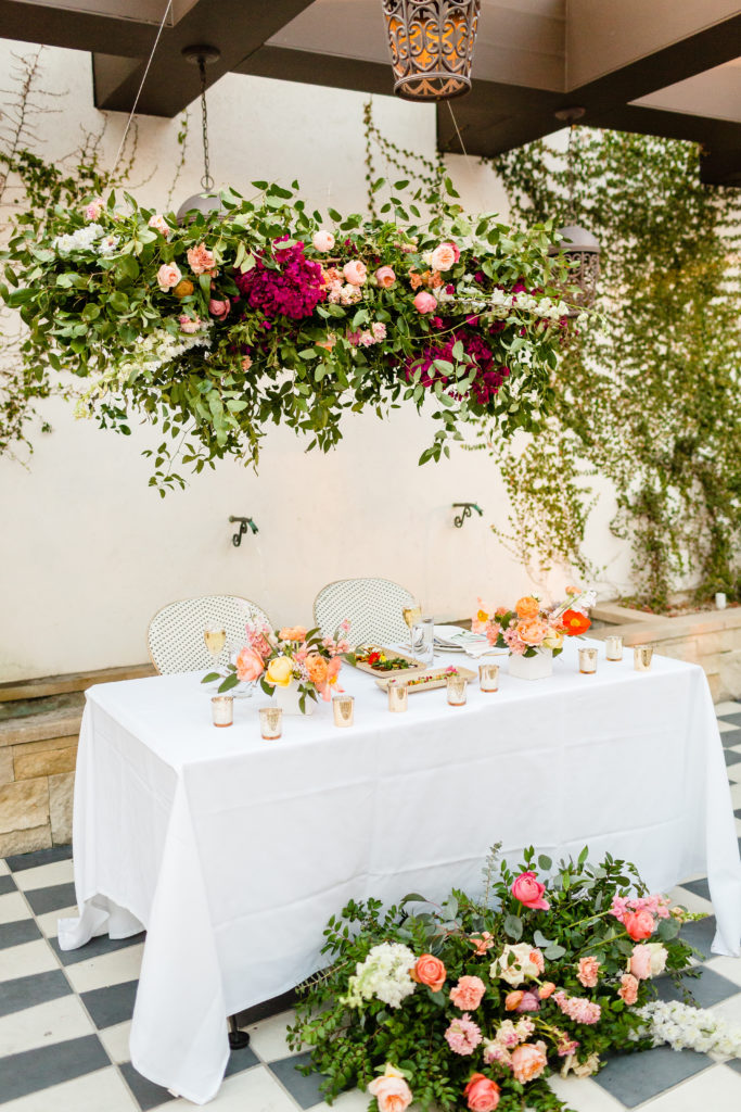 sweetheart table at Ricks with hanging floral installation and french cafe chairs
