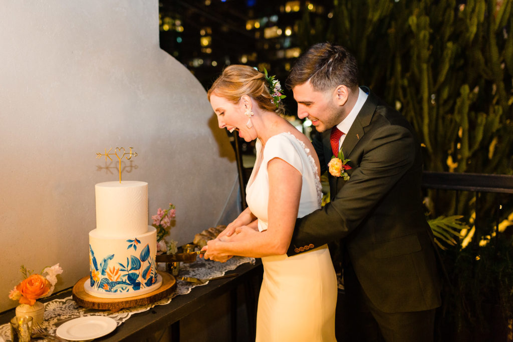 Bride and groom cutting cake at their spring wedding at Hotel Figueroa