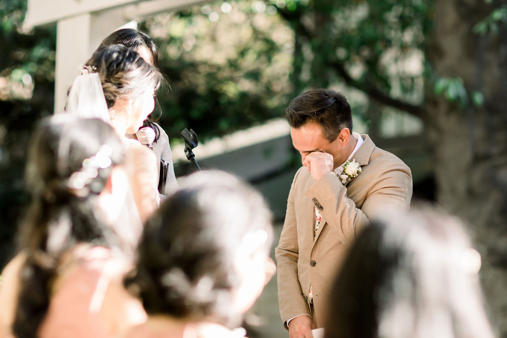bride and emotional  groom during their wedding ceremony at the Redwood Room at Calamigos Ranch