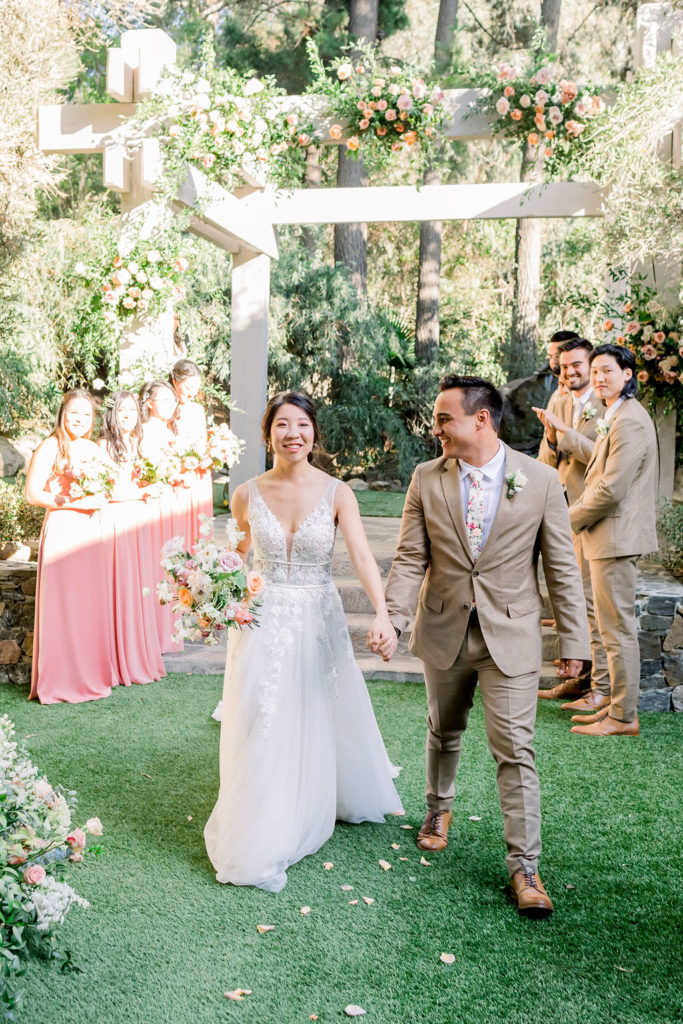 bride and groom recessional during their wedding ceremony at the Redwood Room at Calamigos Ranch