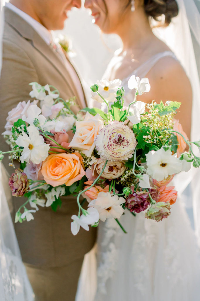 wild and loose bridal bouquet with orange, beige and white florals