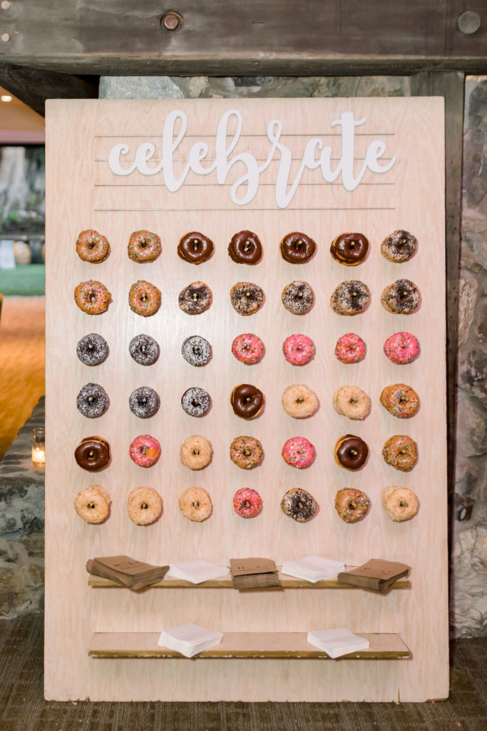 giant donut wall with the words "celebrate" for this enchanting wedding reception at Calamigos Ranch