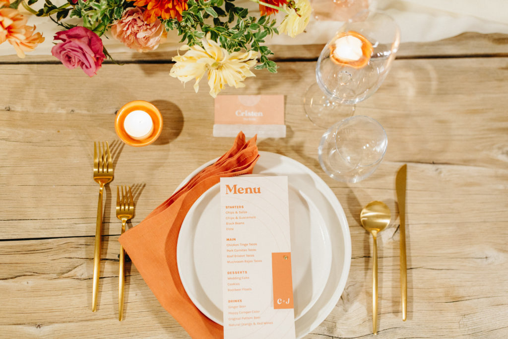 wedding reception in Joshua Tree for small guest count with bright orange, red and yellow tones and mid-century style menu