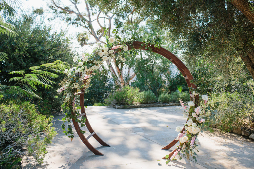 Wedding ceremony with wooden chairs and circle arch for an autumn wedding in the Santa Monica Mountains