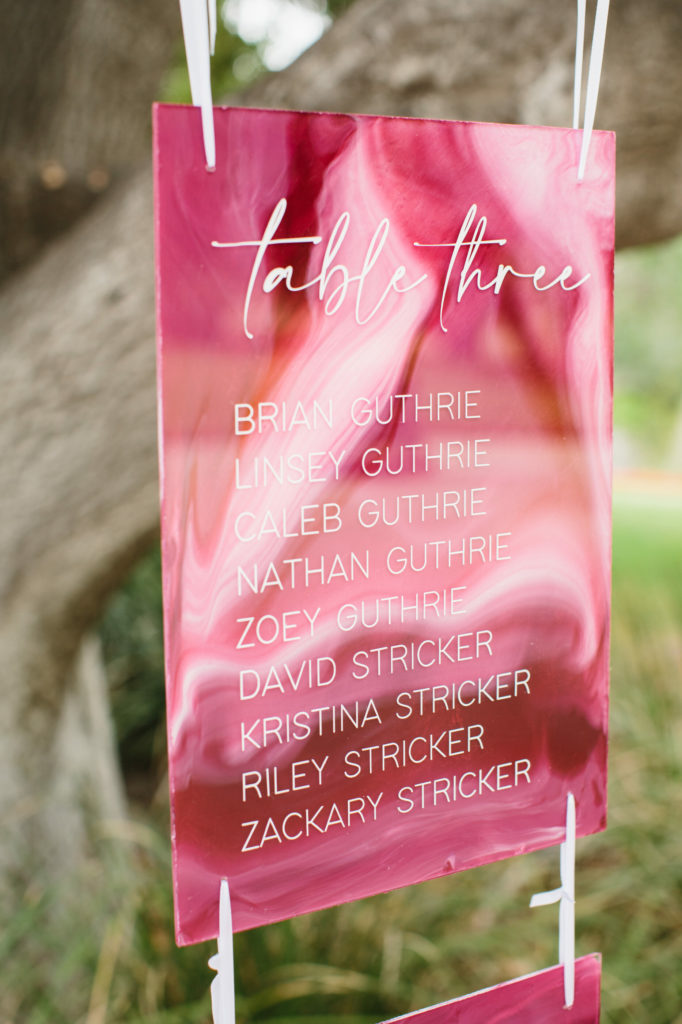 pink acrylic hanging seating chart for wedding reception