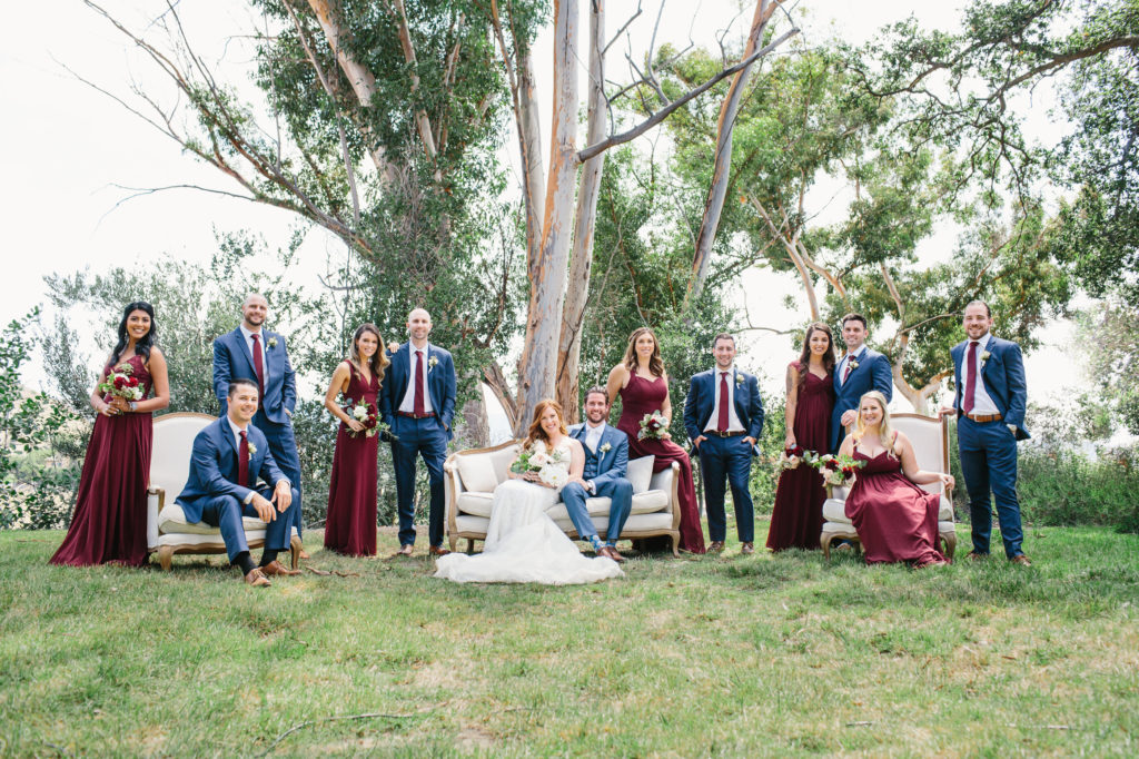 wedding party with blue suits and burgundy dresses