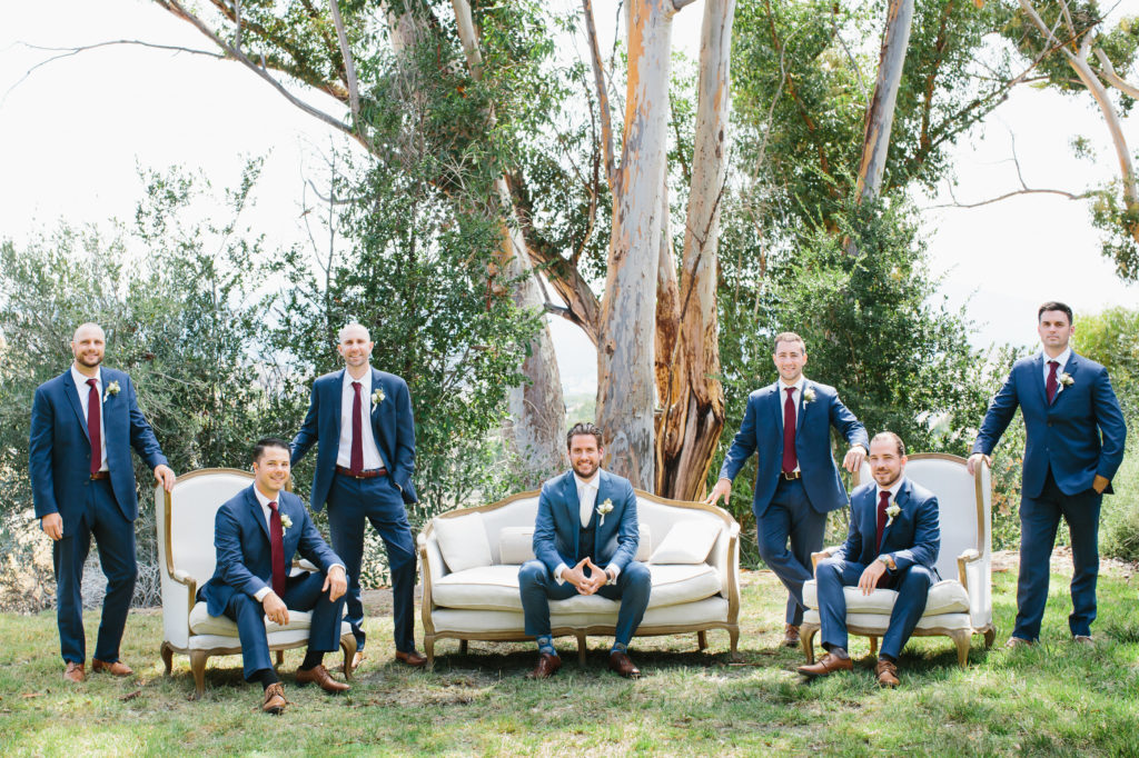 groom and groomsmen in blue suits on a couch
