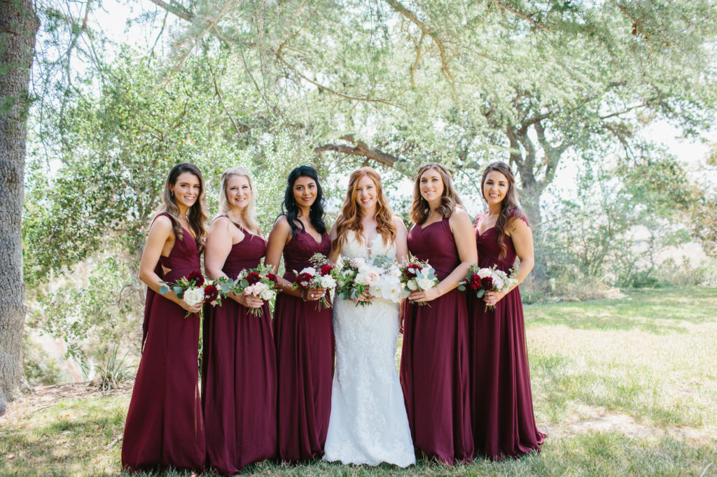 bride with bridesmaids in burgundy dresses
