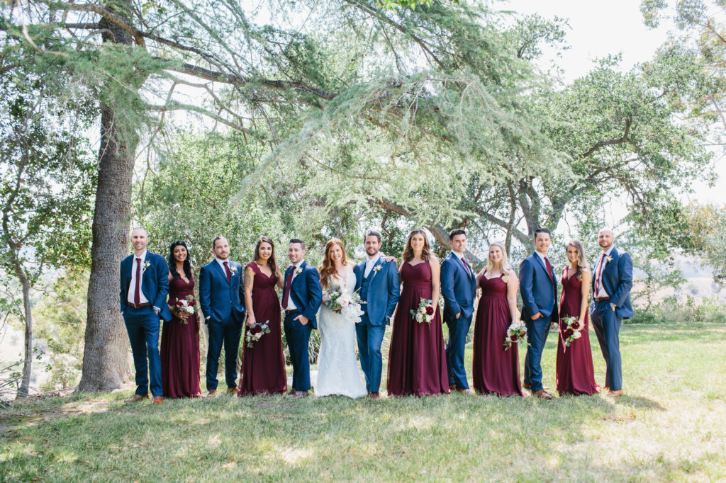 wedding party with blue suits and burgundy dresses