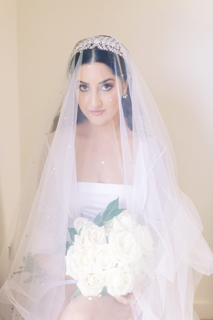 bridal portrait shot with bouquet in robe and veil