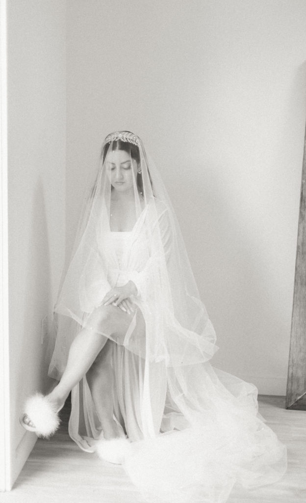 bridal portrait shot with bouquet in robe and veil