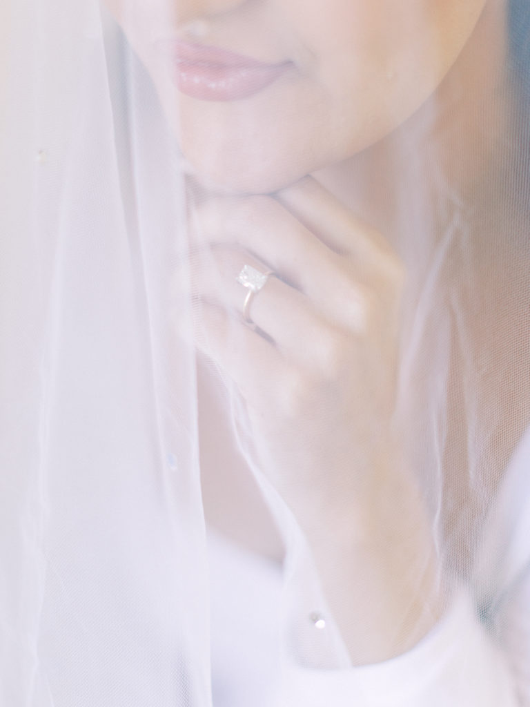 ring detail shot through bridal veil