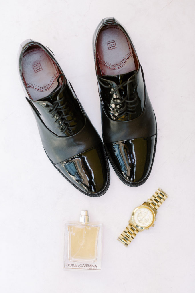 black tuxedo shoes and gold watch 
