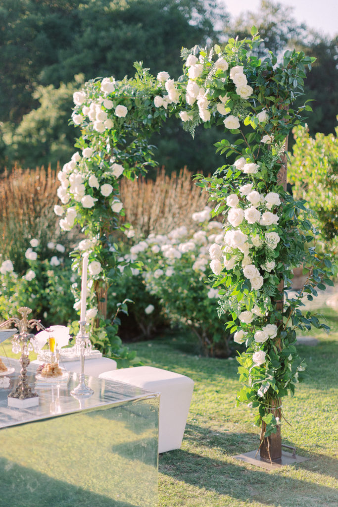 Persian wedding ceremony at Saddlerock ranch with white rose arch