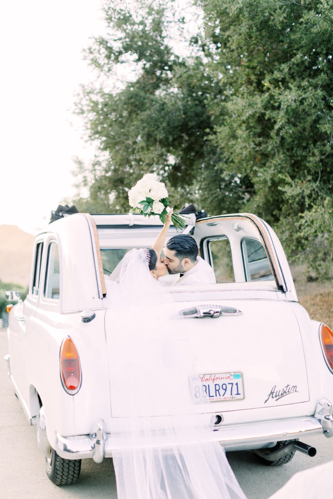bride and groom portrait shots in vintage white car at Saddlerock Ranch