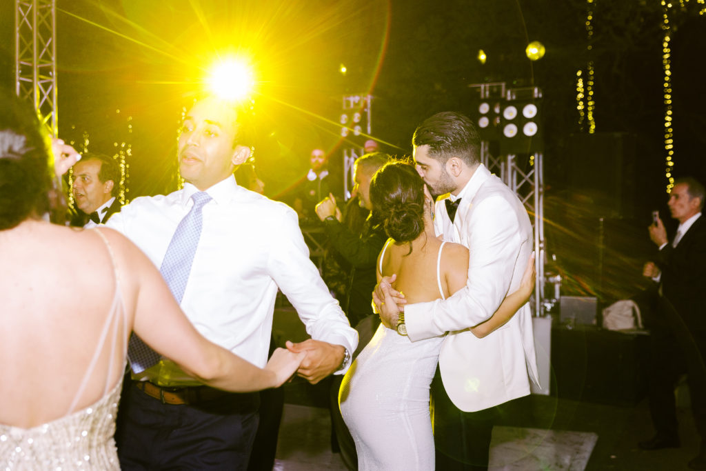 bride in reception dress dances with groom