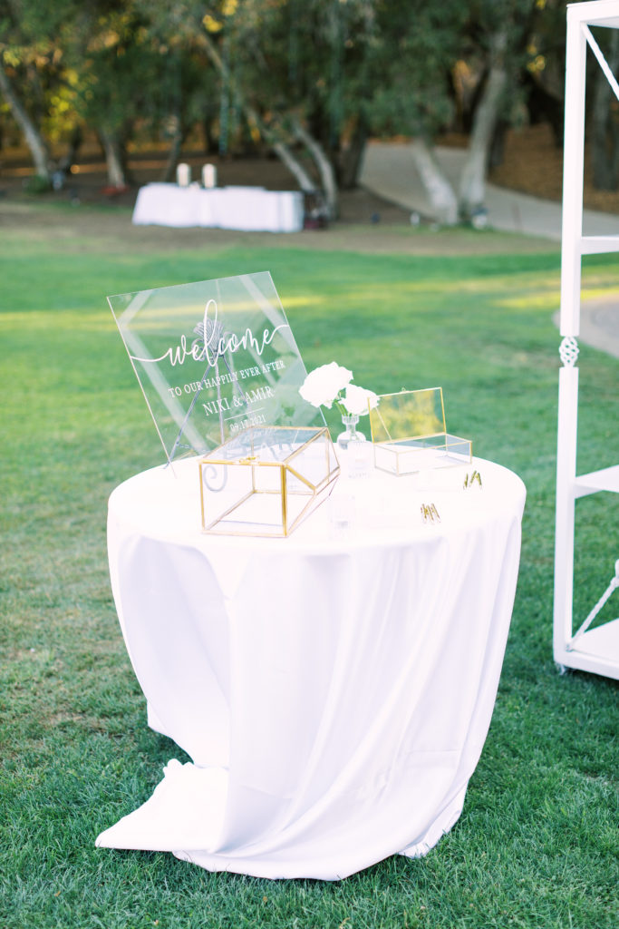 acrylic wedding welcome sign with gold card box at white-tie wedding
