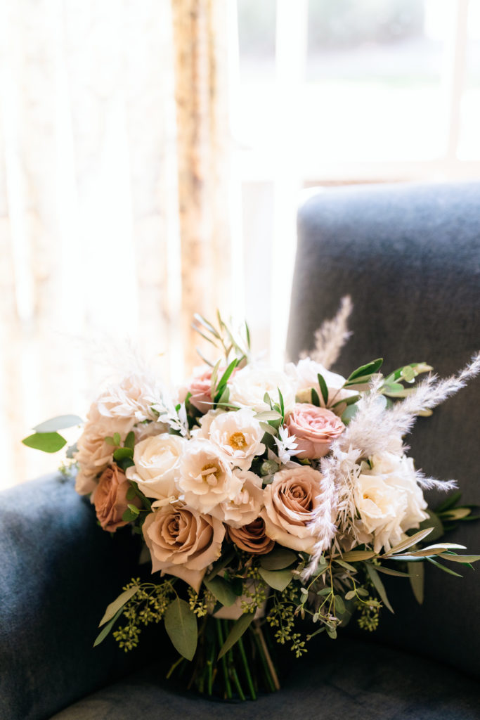 bridal bouquet with dusty pink and white roses and pampas grass