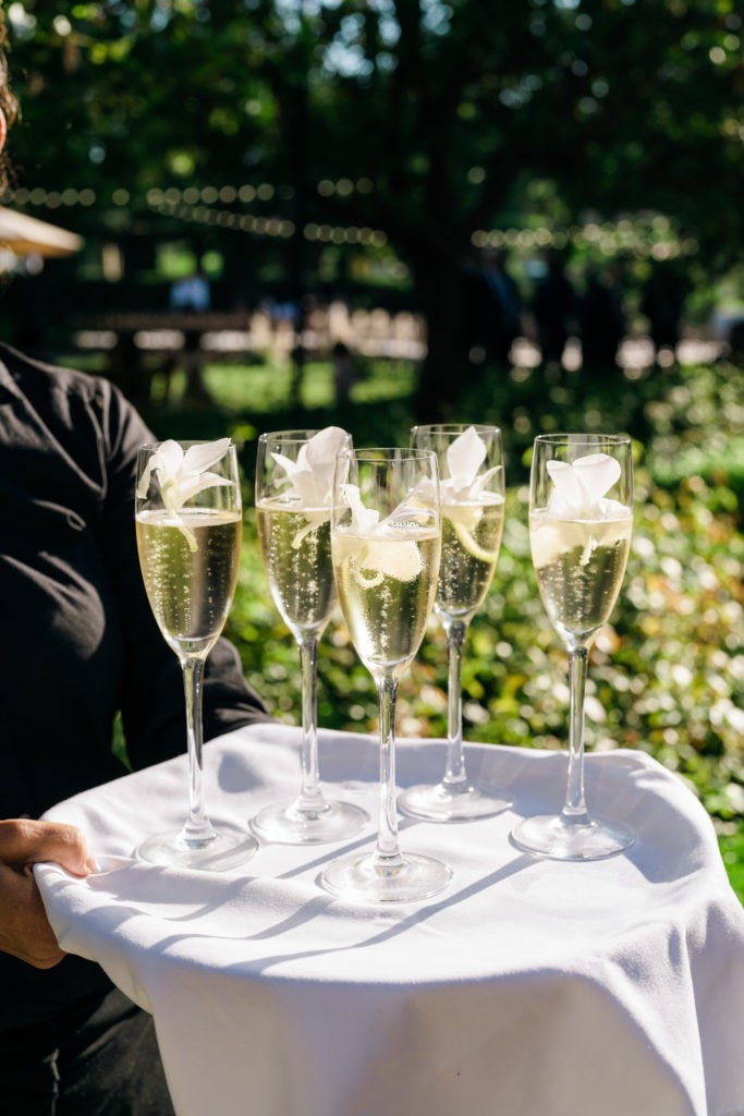 champagne flutes greet guests at wedding ceremony