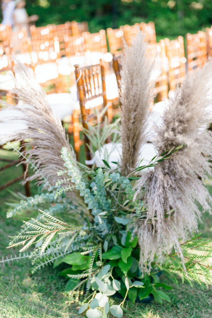 neutral color palette wedding ceremony with pampas grass lining aisle