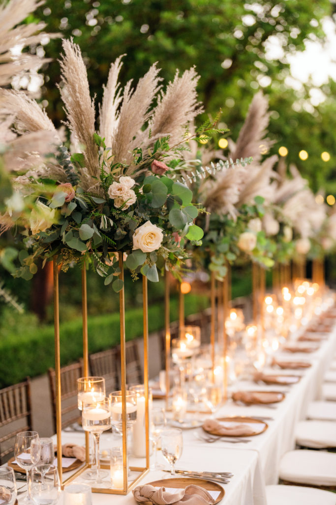 tall gold framed floral centerpieces with roses and pampas grass