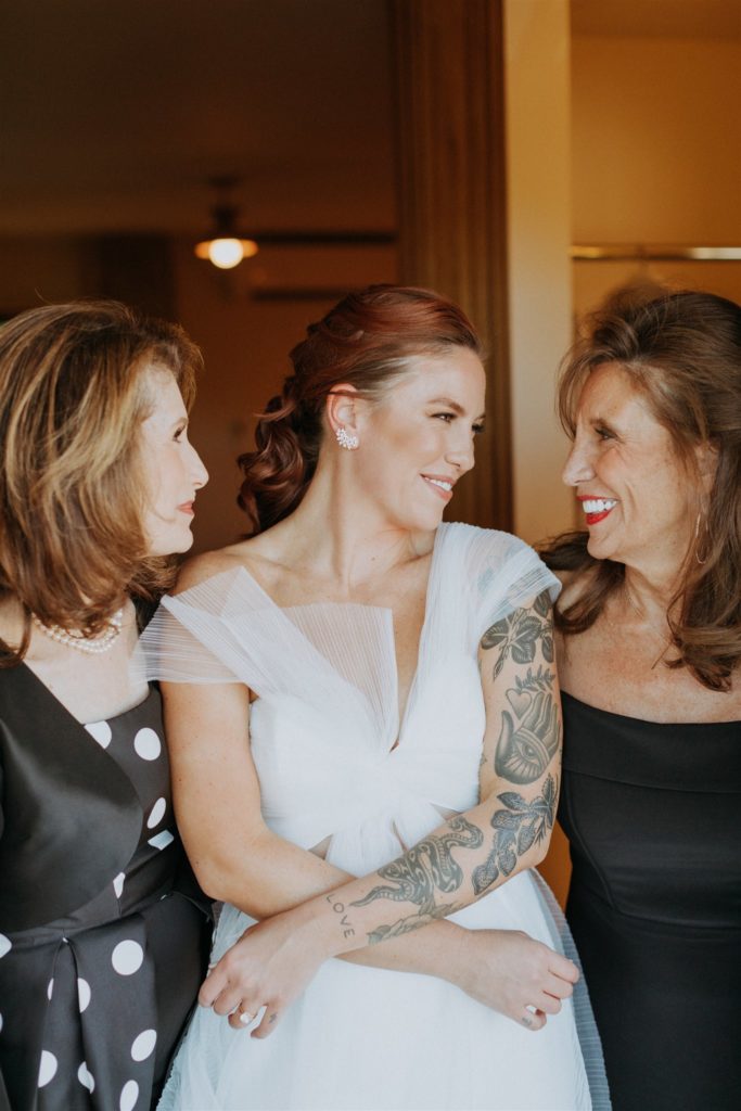 bride in asymmetrical dress with mother and soon to be mother-in-law
