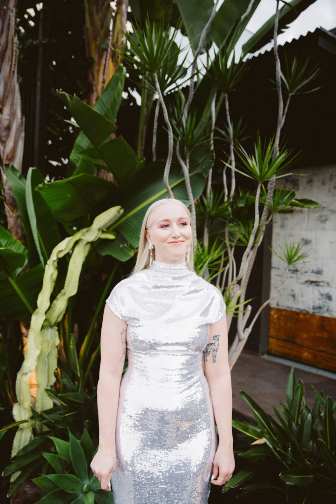 bride with long straight blonde hair wears silver wedding dress
