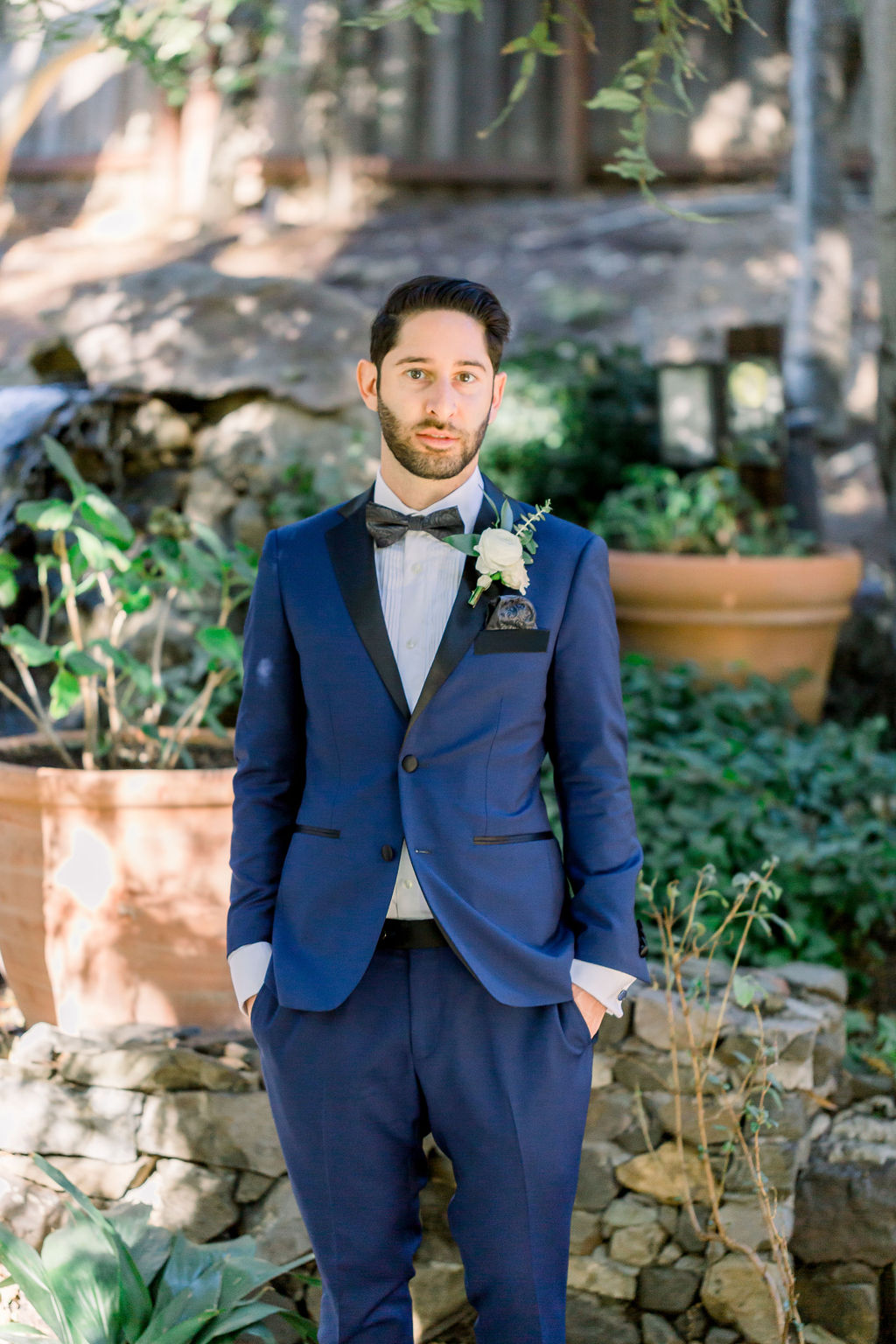 groom with paisley detail bowtie and blue tuxedo 