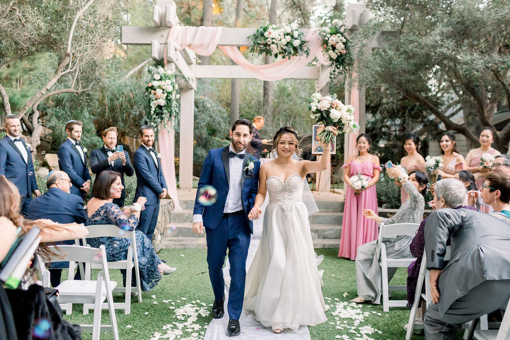 bride and groom recessional after romantic + glamorous wedding ceremony celebrating two cultures