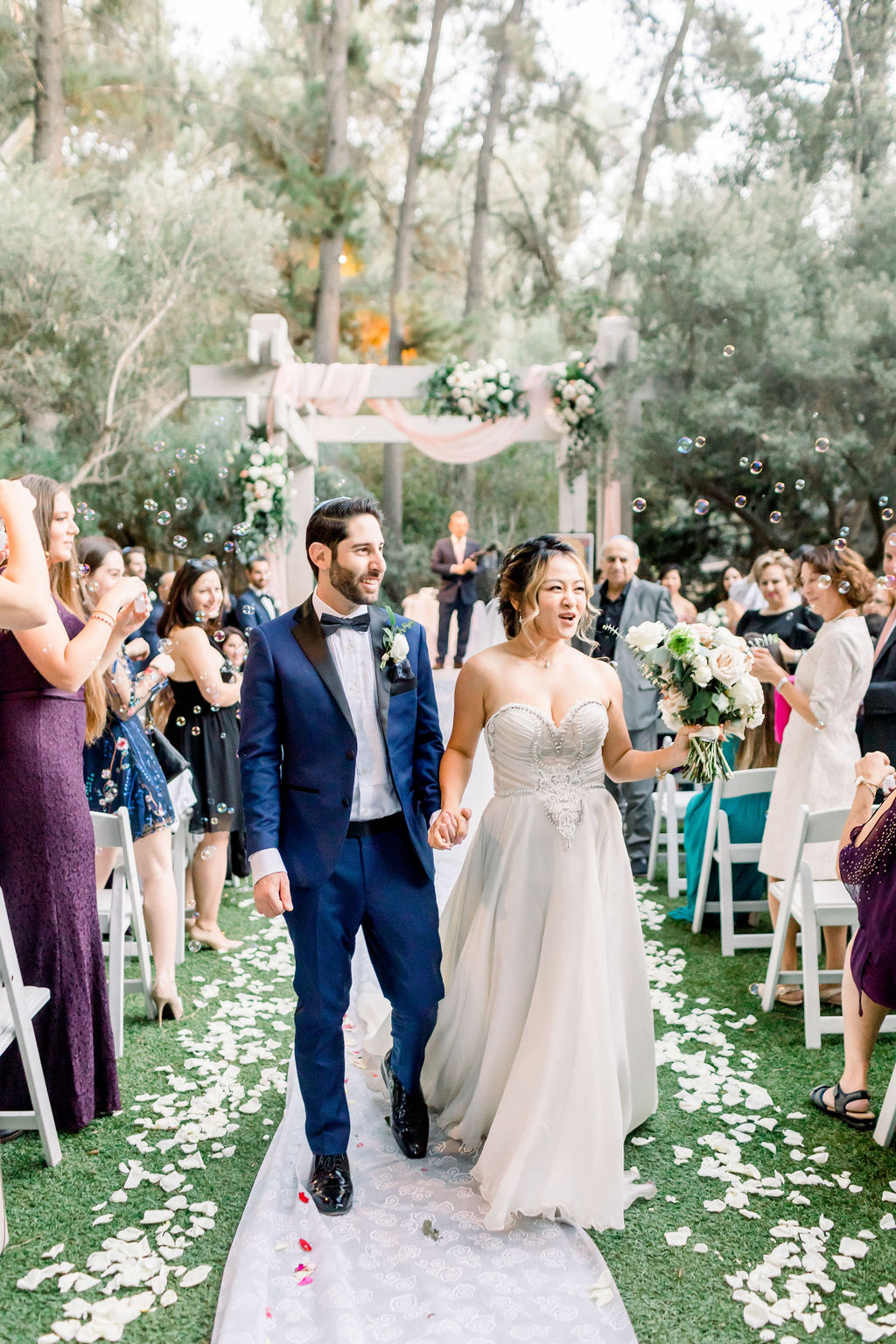 bride and groom recessional during romantic and glamorous wedding ceremony at Calamigos Ranch