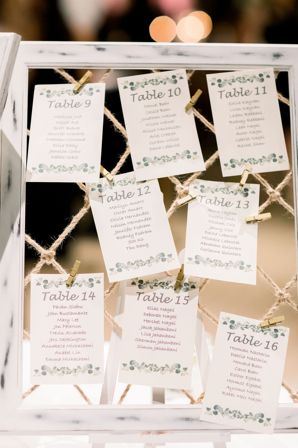 seating chart attached to rustic frame with rope