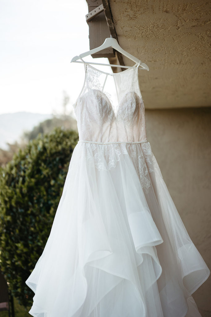 tiered ballgown wedding dress with lace detail on sweetheart neckline and champagne silk lining