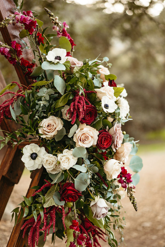 ceremony floral arrangement with roses, eucalyptus and white anemone