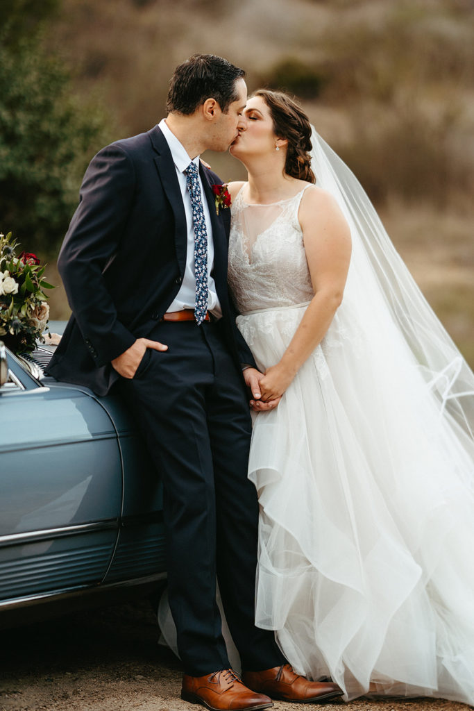 bride and groom take portrait shots with vintage blue Mercedes 