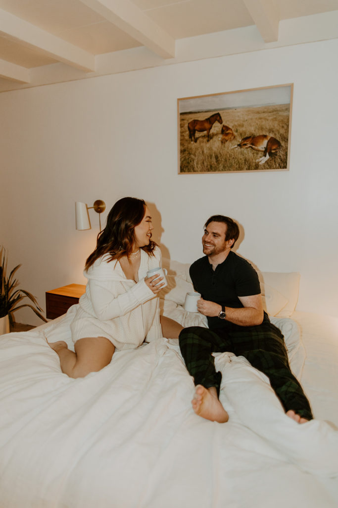 engaged couple drinking coffee in bed during engagement photo session in Palm Springs