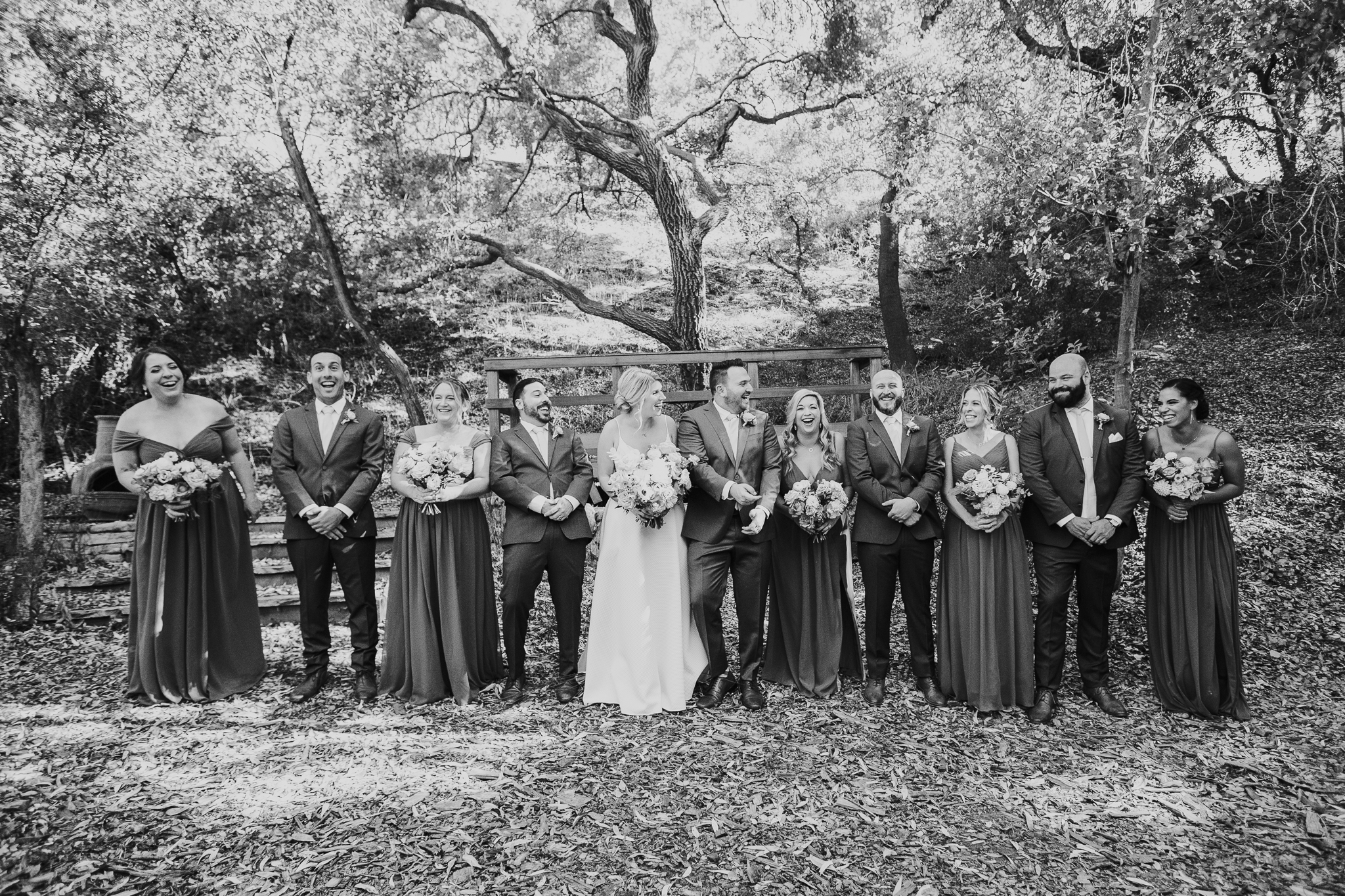 bride and groom stand with their wedding party before wedding ceremony