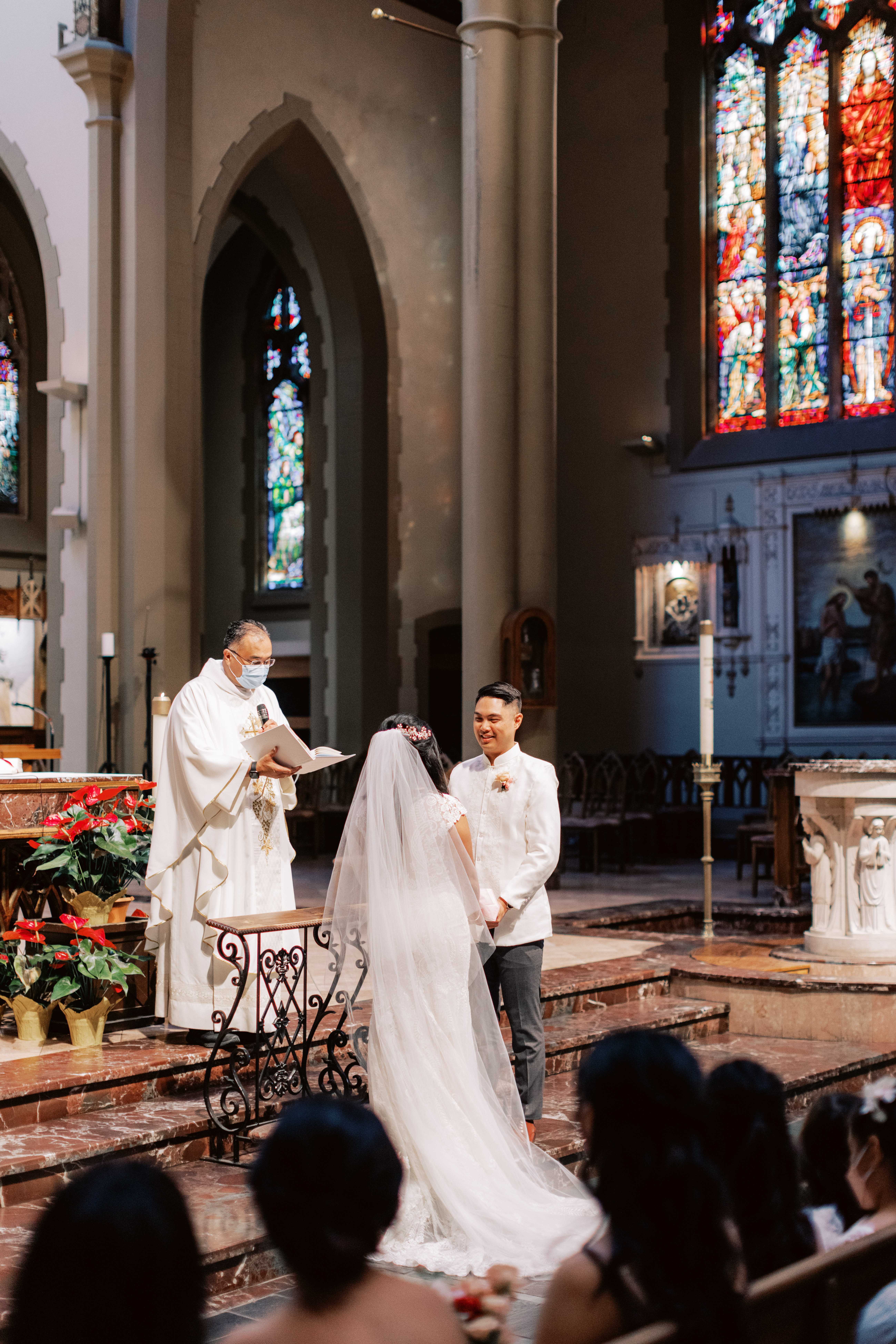 bride and groom standing at altar during Catholic Church wedding ceremony