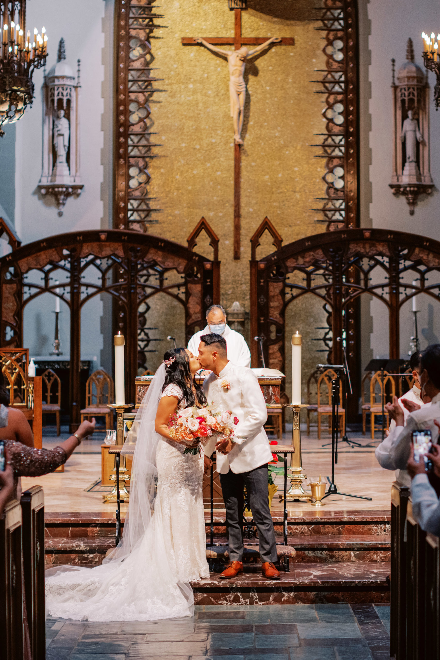bride and groom first kiss during church wedding ceremony