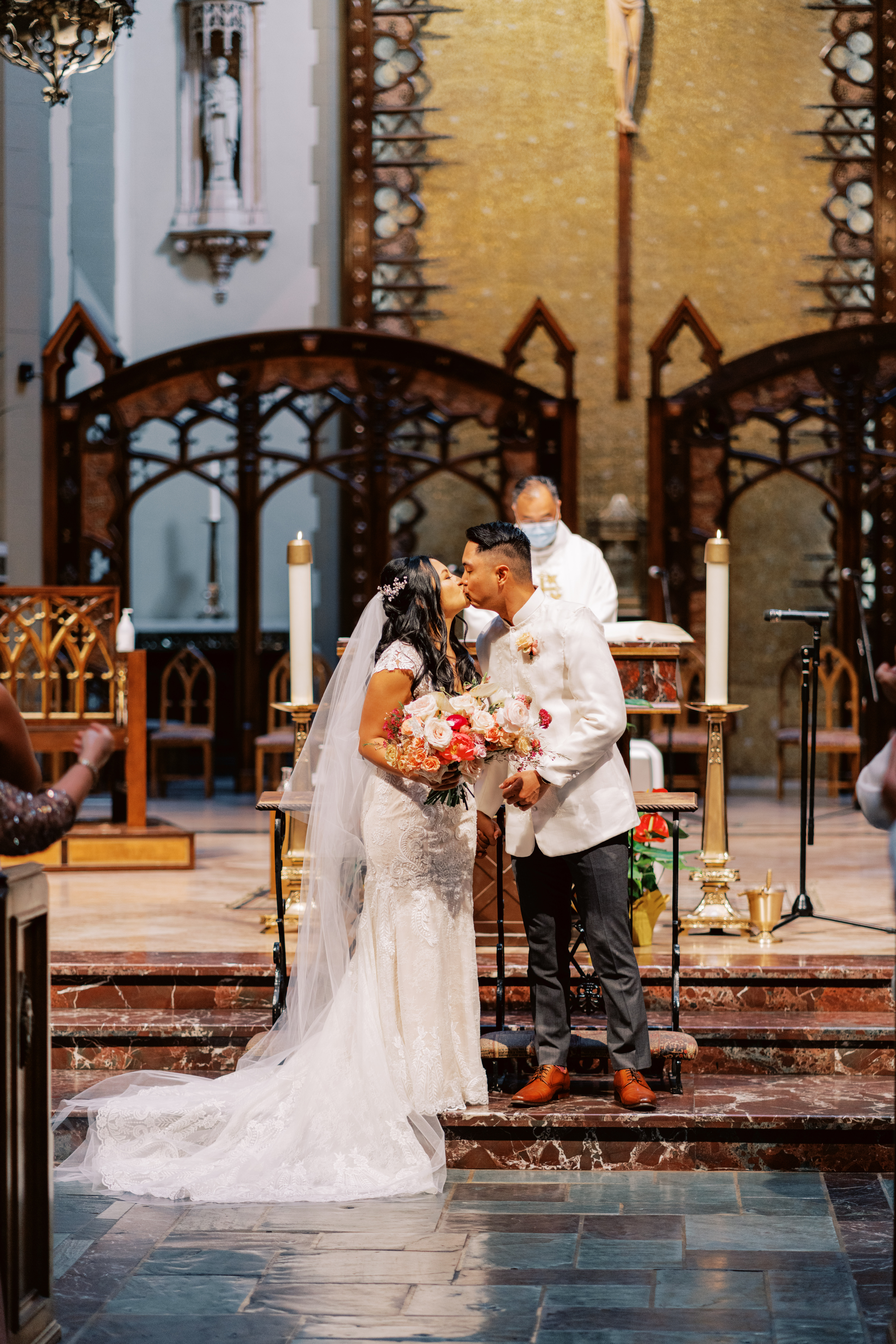 bride and groom first kiss during church wedding ceremony
