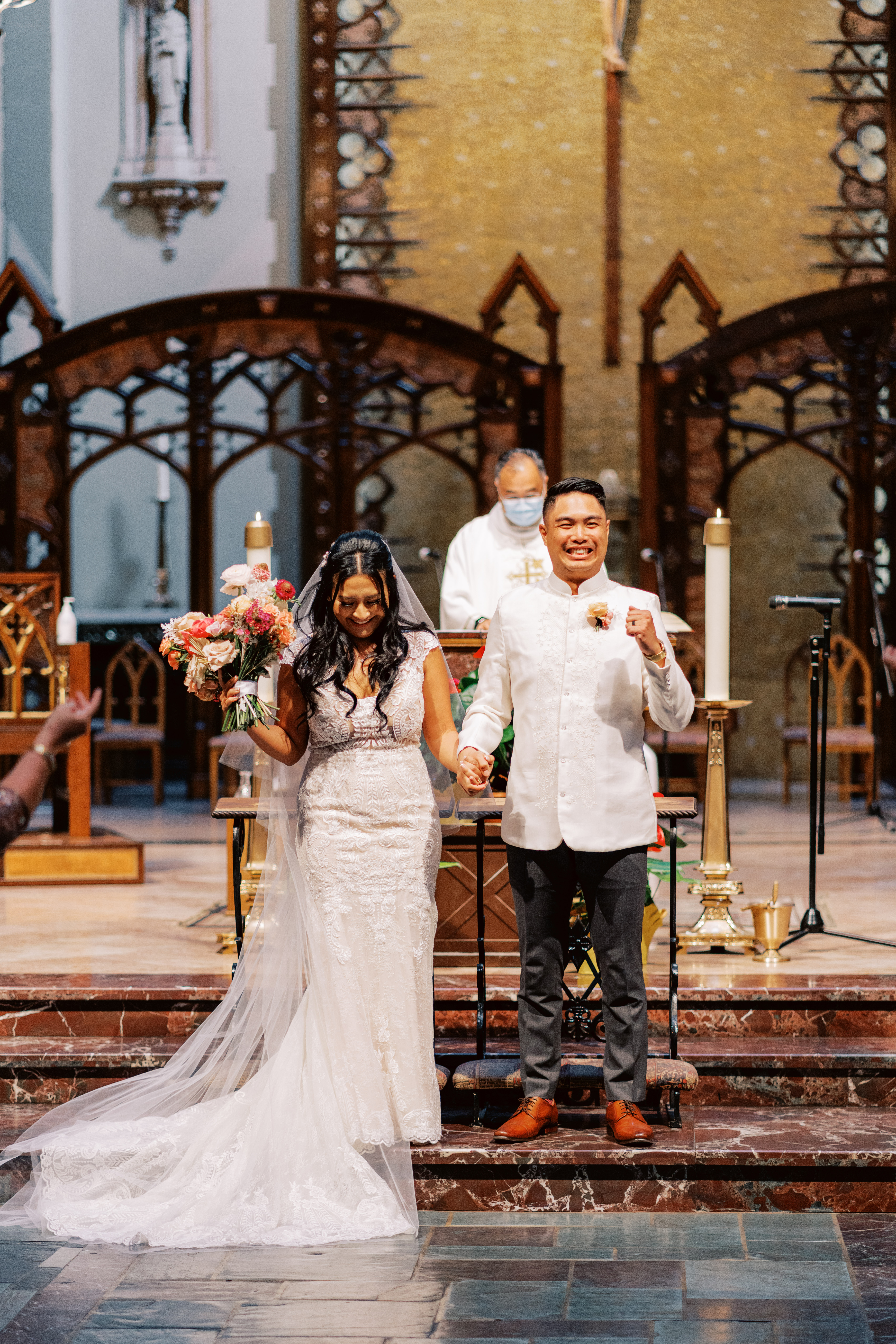 bride and groom recessional down altar at Catholic Church wedding ceremony