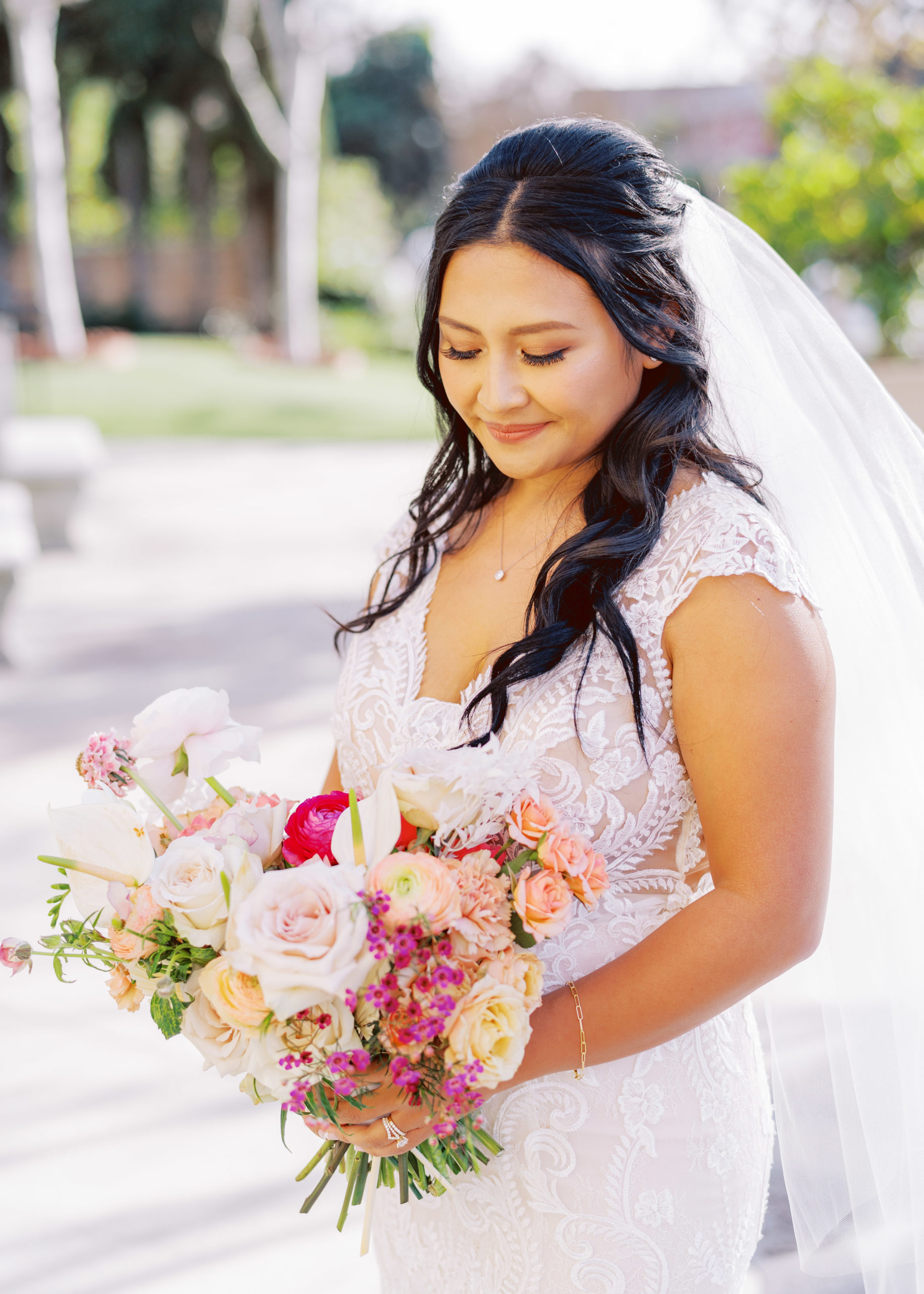 bride in lace wedding dress and tropical floral bouquet 