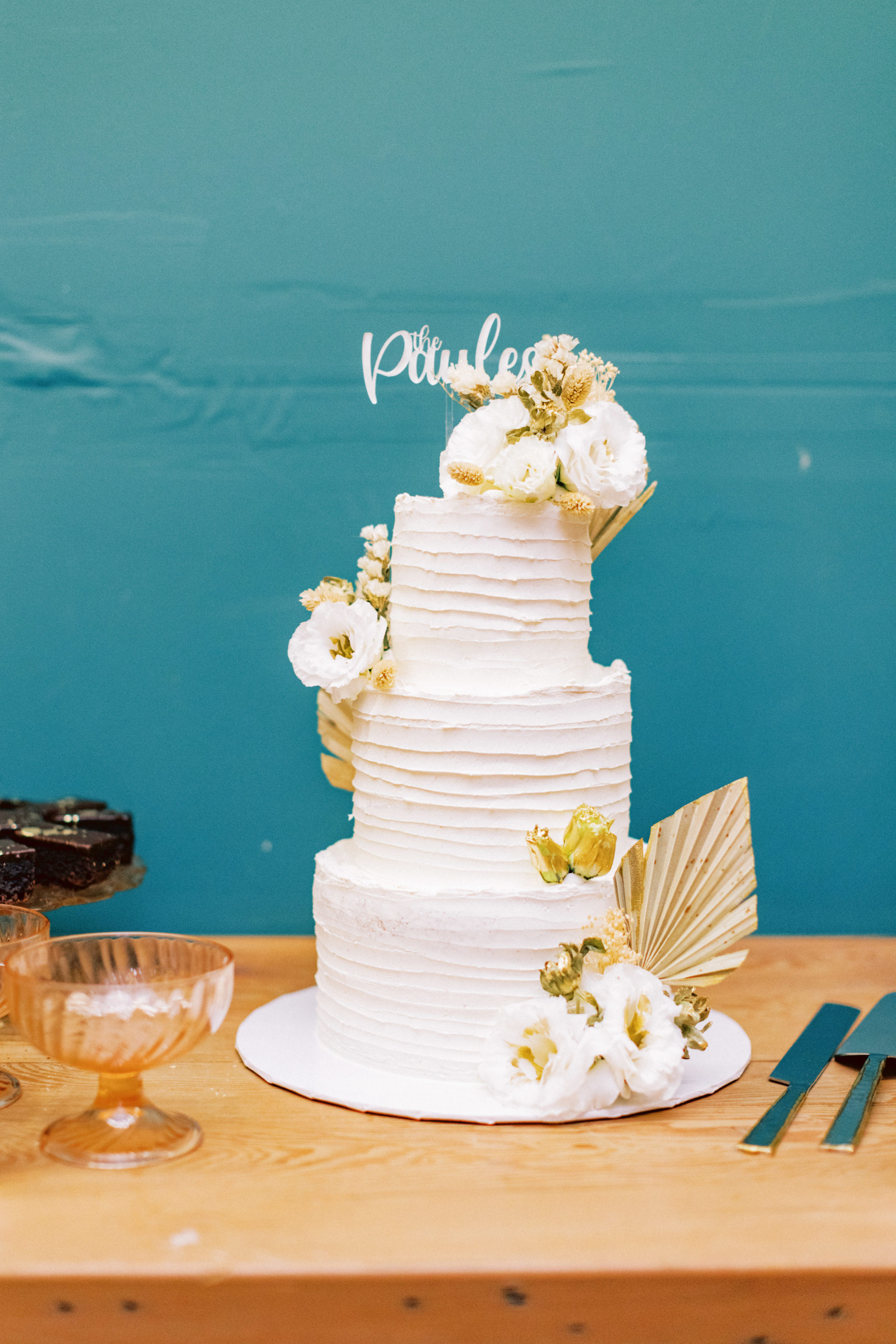 three tier white wedding cake with flowers