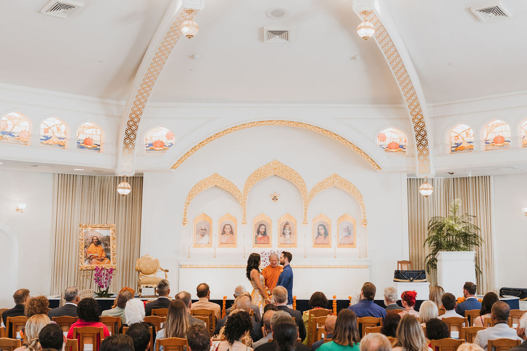 Hindu and Christian wedding ceremony at Lake Shrine Temple in Malibu with orange color palette