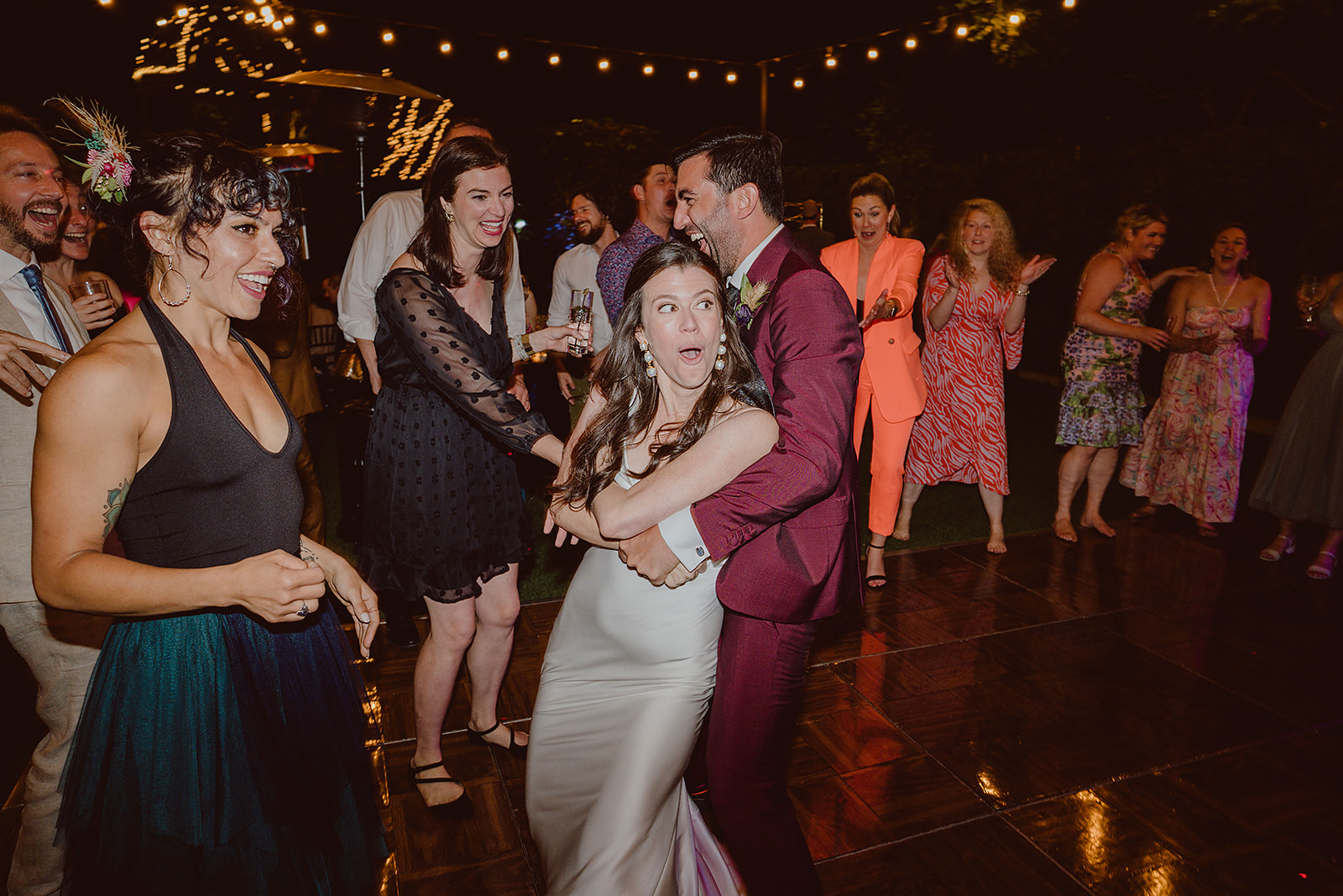 bride and groom dance with guests at wedding reception at The Houdini Estate
