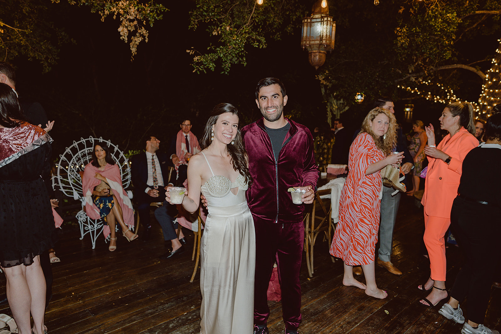 bride in satin and gem bodice reception dress with groom in burgundy track suit enjoying their wedding reception at The Houdini Estate