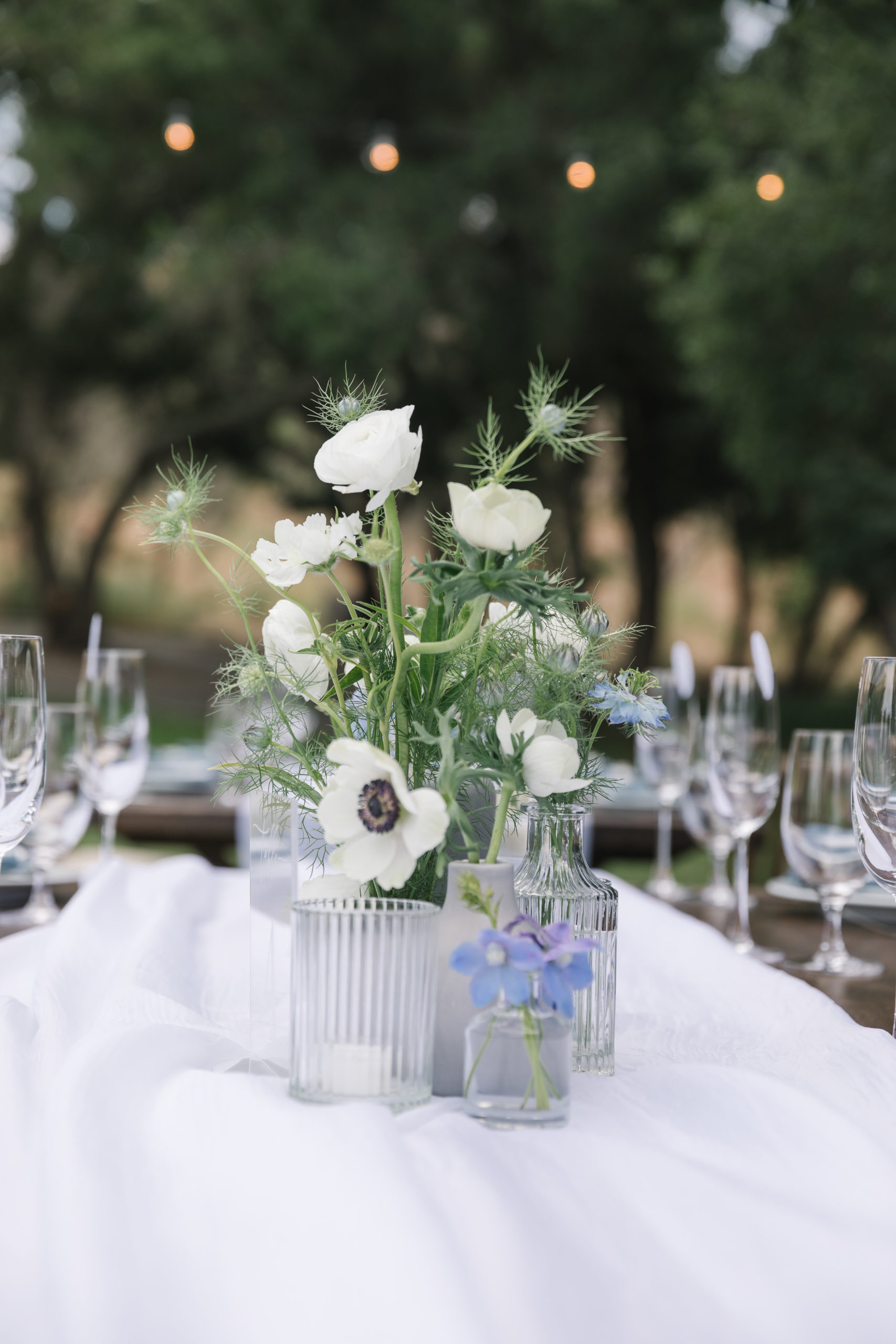romantic blue toned wedding reception at Saddlerock Ranch with farm tables, wooden chairs, and modern details 