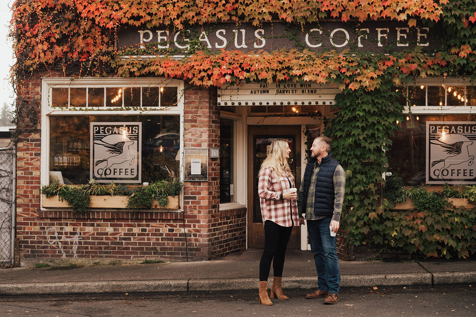 couple in Seattle coffee shop during fall engagement photo session