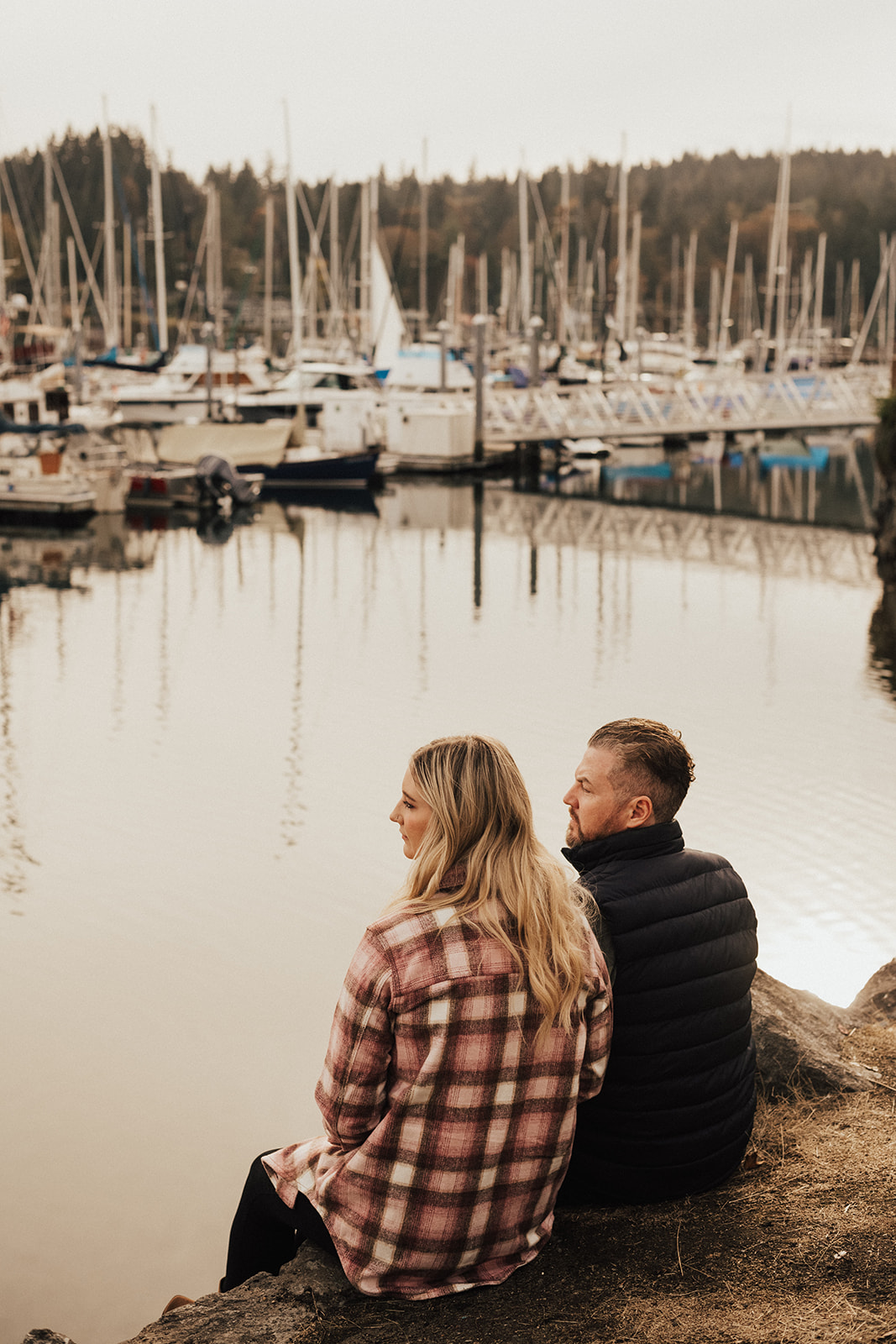engaged couple looking at boats 