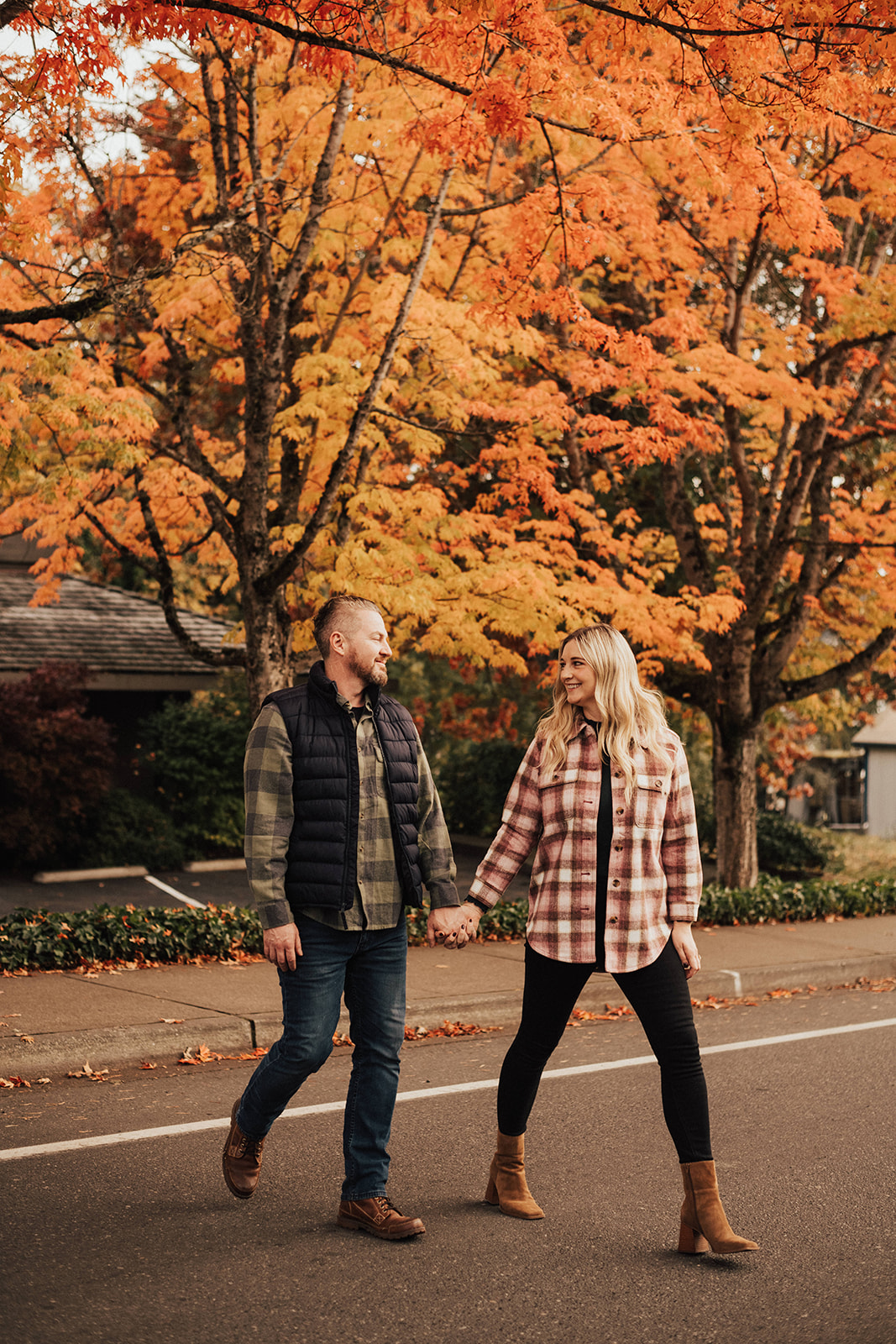 fall engagement photo session with couple holding hands while walking down the street in Seattle